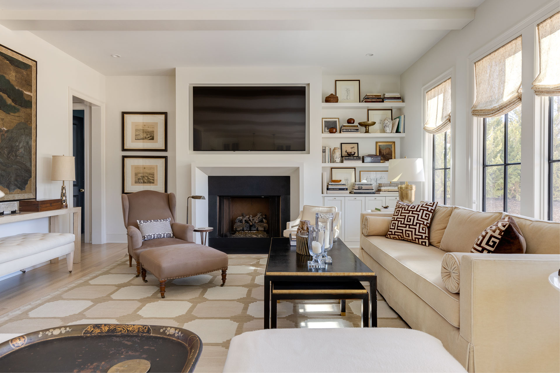 Living room in neutrals with a black and gold coffee table displaying luxury real estate photography in Chapel Hill, North Carolina.